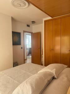 a bedroom with a bed and a wooden cabinet at Suitte Catalunya in Calafell