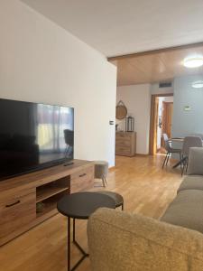 a living room with a large flat screen tv at Suitte Catalunya in Calafell