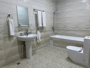a bathroom with a sink and a toilet and a tub at Art Angren Hotel in (( Sotsgorod )) +29 photos