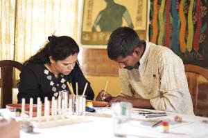 a man and a woman sitting at a table at Surwahi Social Ecoestate Kanha in Kānha