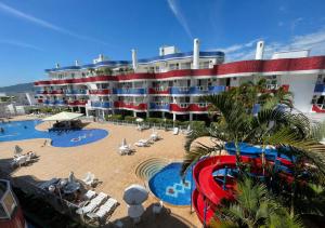 a large building with a pool and a resort at Ingleses Holiday Studios in Florianópolis