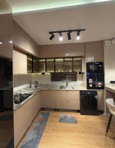a large kitchen with a sink and a stove at Premium 2 Bedroom Maisonette with Ps5 & Pool in Lekki