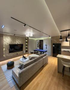 a living room with a couch and a table at Premium 2 Bedroom Maisonette with Ps5 & Pool in Lekki