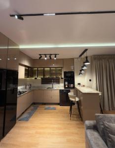 a large kitchen and living room with a couch and a table at Premium 2 Bedroom Maisonette with Ps5 & Pool in Lekki +12 photos