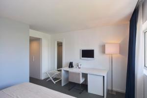 a white room with a desk and a lamp at Grace Smart Design Hotel - "Hotel Anjo de Portugal" in Fátima