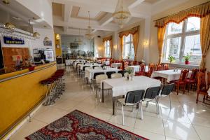 a restaurant with tables and chairs and a bar at Hotel Vyšehrad in Turčianske Teplice
