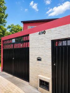a building with two garage doors and a red roof at Casa Adriê in Itacaré