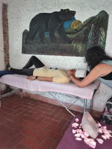 a woman and a man laying on a bed at Villa Jucumarini in Coroico