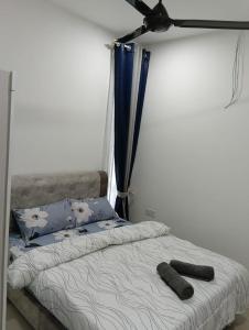 a bedroom with a bed with two objects on it at SD Homestay in Bachok