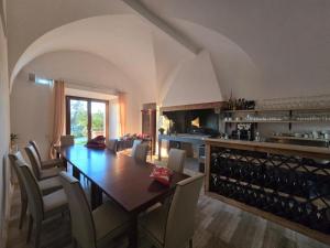 a dining room with a table and chairs and a kitchen at Agriturismo Mamma Maria in Montefiascone
