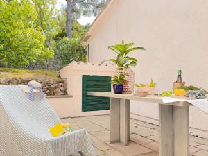 a table and a chair on a patio at Orizzonte Blu - HelloElba in Marciana Marina +65 photos