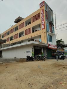 a building with motorcycles parked in front of it at Anand palace lodge in Ghatgān