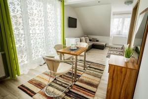 a living room with a table and chairs at Hotel Vyšehrad in Turčianske Teplice