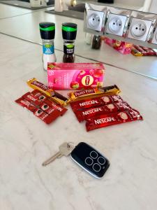 a counter with a bunch of candy and a pair of scissors at Olimpia Luxury Apartment in Lębork