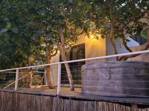 a large barrel sitting on a deck next to trees at היחידה - Hayehida in Ma'alot Tarshiha