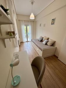 a bedroom with a bed and a desk with a lamp at Alimos Signature in Athens