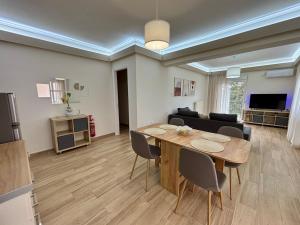 a living room with a table and a couch at Alimos Signature in Athens