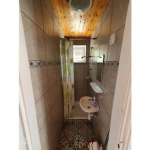a small bathroom with a sink and a toilet at Napfény Apartman in Bogács +11 photos