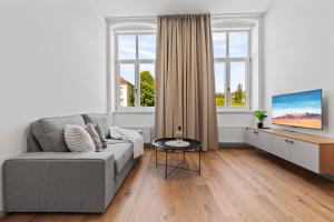 a living room with a couch and a tv at Villa Šanca in Bratislava