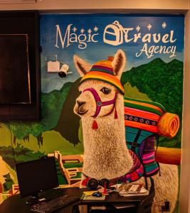 a statue of a llama on a desk in front of a wall at Magic Packer Hostel in Cusco