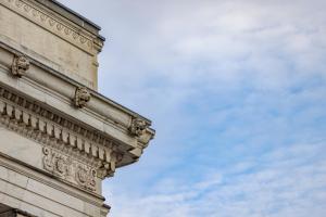 a corner of a building with a cloudy sky in the background at The Promissory Hotel in Roanoke