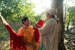 a man and a woman standing next to a tree at Hotel Waya Guajira By OxoHotel in Albania
