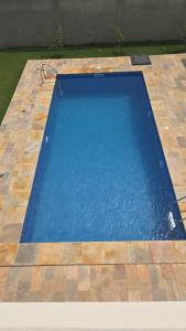 an empty swimming pool on a tiled floor at Villa Hùéfa in Ouidah
