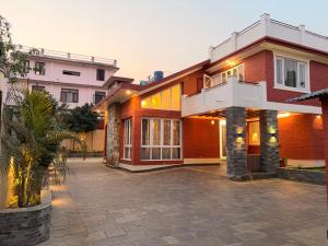 a house with a courtyard in front of it at Fu Shang Villa in Kathmandu