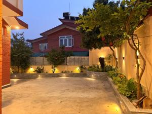 a courtyard in front of a house at night at Fu Shang Villa in Kathmandu +11 photos