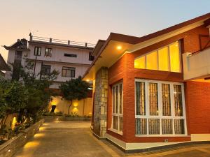 a brick house with a building in the background at Fu Shang Villa in Kathmandu