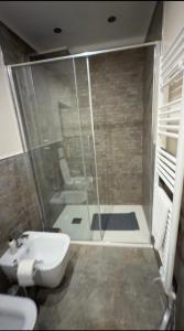 a bathroom with a shower with a toilet and a sink at Alloggio del Trap in Ferentillo