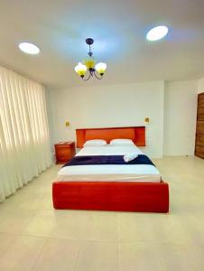 a bedroom with a large red bed in a room at Hostal Marle in Portoviejo