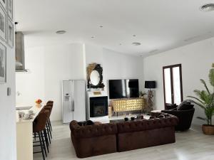 a living room with a couch and a fireplace at Casa de la luz in Cartagena +6 photos