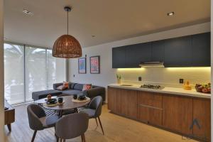a kitchen and a living room with a table at Be Local Lofts & Coworking in Mexico City