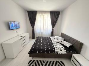a bedroom with a bed and a television in it at RC RelaxApart 15 in Dudu