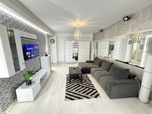 a living room with a couch and a tv at RC RelaxApart 15 in Dudu