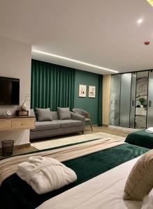a living room with a couch and a television at Blue Pyramids Eyes Hotel in Cairo