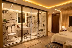 a bathroom with a shower and a toilet and a sink at Blue Pyramids Eyes Hotel in Cairo