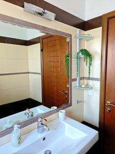 a bathroom with a sink and a large mirror at Vista Mare Aegina in Kipséli +40 photos
