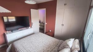 a bedroom with a bed and a flat screen tv at Casa Tropical in Costa de Antigua +22 photos