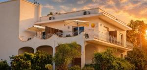 a white building with umbrellas on top of it at RestHouse The Village in Nardò
