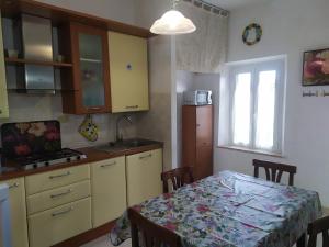 a kitchen with a table and a table and a dining room at Casa delle Onde in Vada