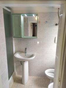 a bathroom with a sink and a toilet at Casa delle Onde in Vada