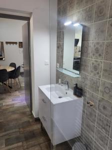 a bathroom with a white sink and a mirror at Maison à la campagne in Tourves +31 photos