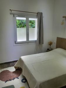a bedroom with a bed and a window at Maison à la campagne in Tourves