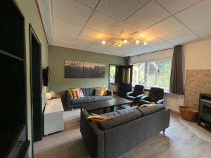 a living room with a couch and a table at Platell Ferienhäuser Harz Lerbach in Lerbach