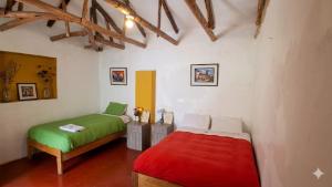 a bedroom with two beds in a room at Coco's vibes in Ollantaytambo