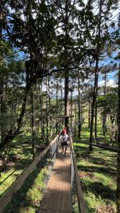 two people walking on a boardwalk in a park at Parador Pôr do Sol in Cambará +75 photos
