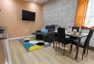 a living room with a table and a couch and a rug at Costa Ovest Apartment 3 in Nurachi