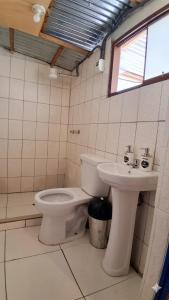 a bathroom with a toilet and a sink at Coco's vibes in Ollantaytambo +15 photos